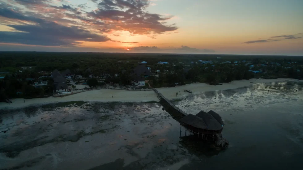 aerial-shot-pier-beach-by-ocean-captured-sunset-zanzibar-africa