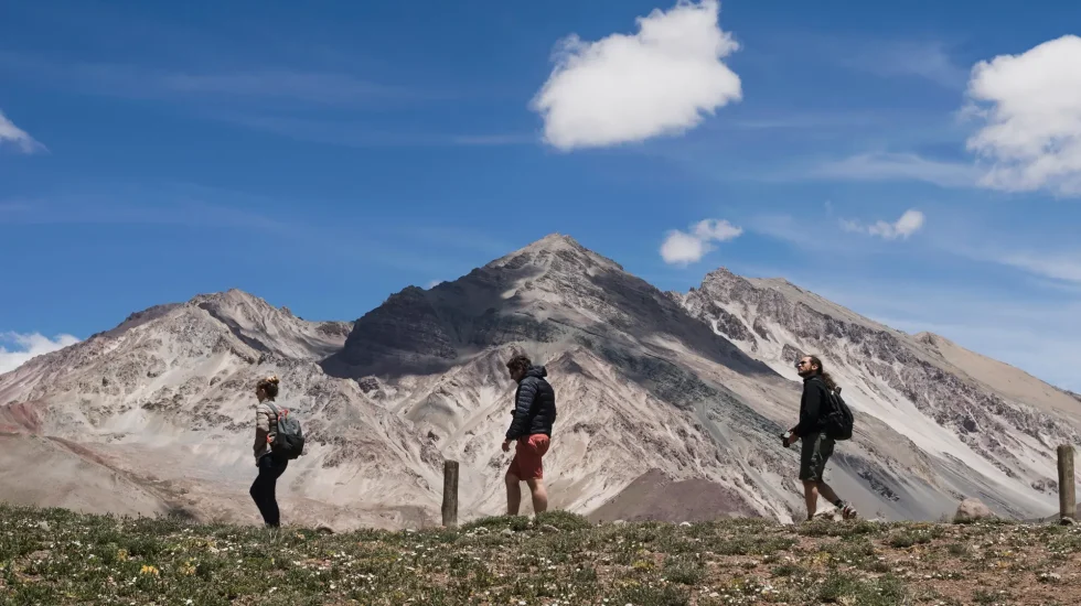 group-hikers-hiking-front-mountain