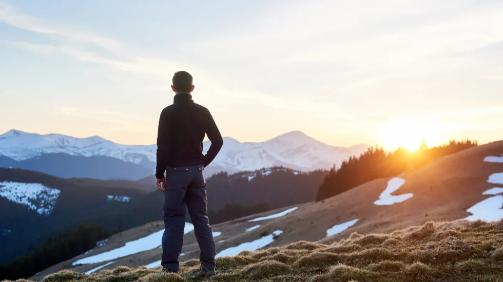 rear-view-male-hiker-watching-wonderful-scenery-mountains-spring-colorful-sunset